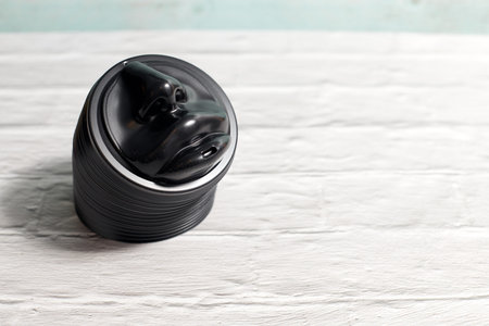 a stack of coffee Cup lids shaped like a person's nose and lips. coffee Cup lid for single people on...