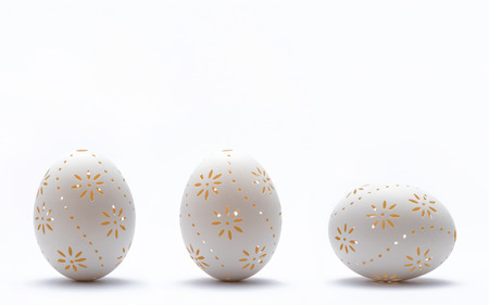 Graven Easter eggs on white background.の写真素材