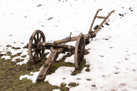 Agricultural old manual plow and wooden wheel.の写真素材
