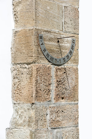 Ancient solar clock on the wall of a rural church in Romania.