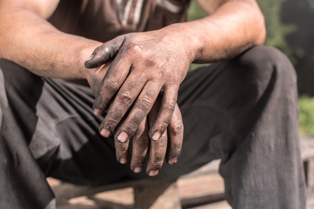 Charcoal-burners worker man with dirty hands.の写真素材