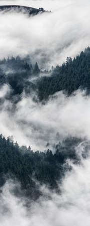 Ink and wash spiritual mountains landscape, traditional japanese landscapes. Scenic foggy atmosphere above mountains by early morning.の写真素材