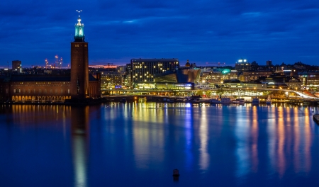 Colourful version of skyline overlooking Stockholm city hall  Reflections of neon lights in the water の写真素材