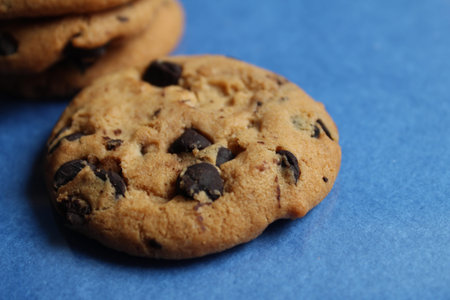 cookies festive round with chocolate drops close up on a blue background there is a copy space for...