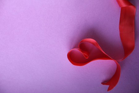 heart of red ribbon on pink background with copyspace place for the text of the background Valentine's Day lovers.の写真素材