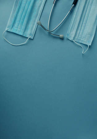 background of the medical mask and stethoscope on a blue blue background with a place for the text of the copyspace.の写真素材
