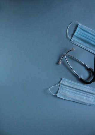 background of the medical mask and stethoscope on a blue blue background with a place for the text of the copyspace.の写真素材