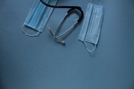 background of the medical mask and stethoscope on a blue blue background with a place for the text...