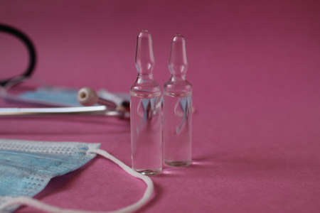 two vials with a vaccine on a pink background with a place for the text of the copyspace.の写真素材