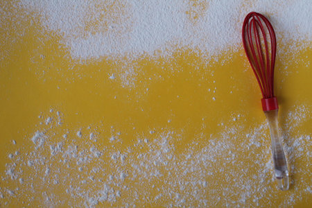 Food yellow background sprinkled with flour or powdered sugar on top and bottom next to the side on...