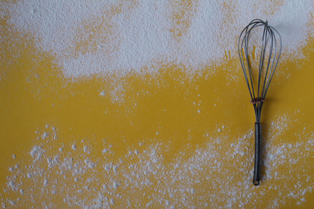 Food yellow background sprinkled with flour or powdered sugar on top and bottom next to the side on the right lies.,の写真素材