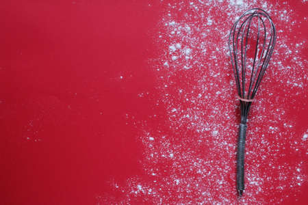 Background food flour or powdered sugar scattered on a red background with meth for text copyspace.の写真素材