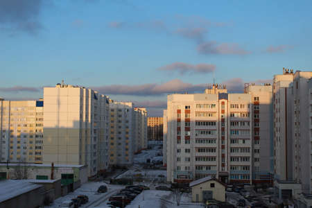The cityscape sunset is a beautiful evening in the city high-rise high-rise buildings in the backyards of cars and blue sky.の写真素材