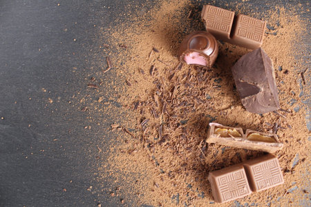 Background International Chocolate Day milky dark chocolate on a gray black background with a...
