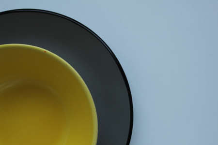 plates of yellow gray on a light white background with a ist for text and a copyspace.の写真素材