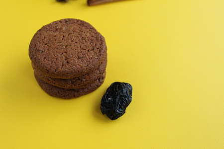 The cookie homemade oatmeal lies a stack of slides on a yellow bright background with room for text and copyspace.の写真素材