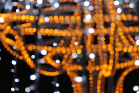 yellow lights on a dark black background. New Year's Eve Christmas background. Festive lighting.