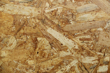background: wood shavings. Shavings Building Board. Use of woodworking waste.
