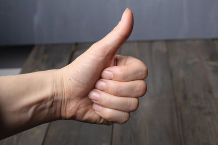 Class sign with a hand on a gray background in close-up. Hand approval. Communication without words.の写真素材