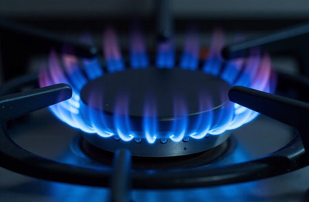 The gas on the burner burns with a blue fire. Gas stove.の写真素材