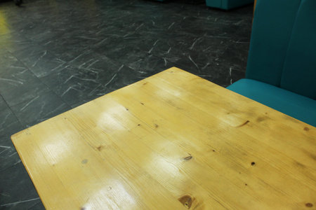 a yellow wooden table in a cafe. Natural wooden furniture. Eco-friendly materials.