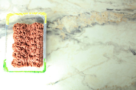 plastic container with minced meat on the table top view meto for copyspace text.