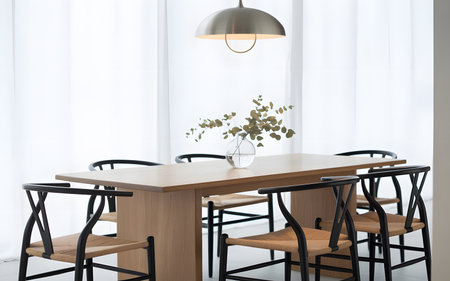 Modern dining room interior with wooden table and chairs.の素材