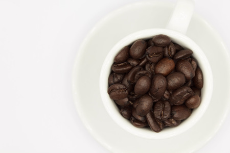 Coffee beans in white cupの写真素材