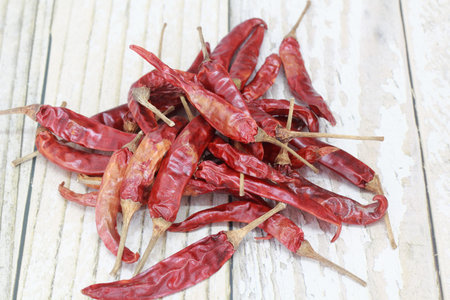 Dried red chili pepper over wooden background in a rustic style