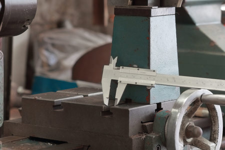 Vernier caliper and lathe machine in the workshop.