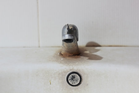 Old dirty faucet in the bathroom. Selective focus.の写真素材