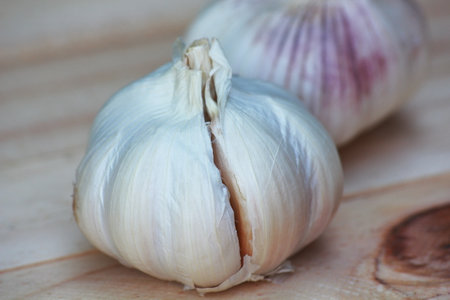 Garlic on a wooden background. Selective focus and shallow depth of field.の写真素材
