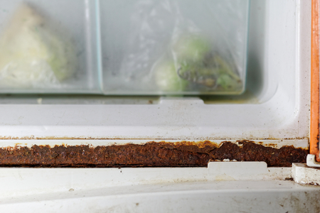 dirty and rusted on refrigerator door frameの写真素材
