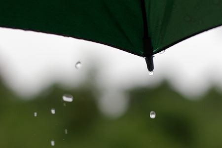 umbrella with rain fallingの写真素材