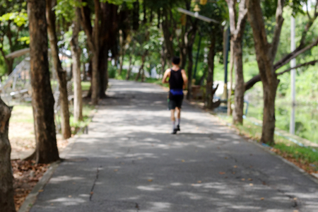 blur people running in the park backgroundの写真素材