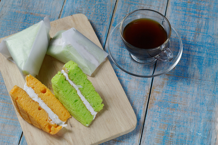 pandan and coconut chiffon cake on a wooden plateの写真素材