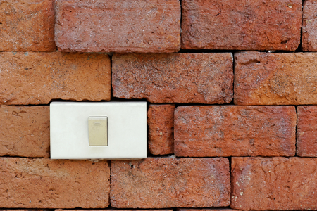 light switch on red brick wallの写真素材