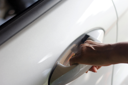 Close up of a Woman opening a car doorの写真素材