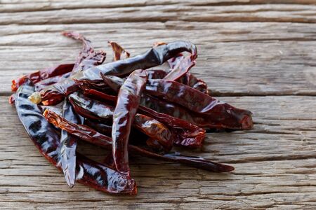 Dried Red Cayenne Pepper hot chili on wood plateの写真素材