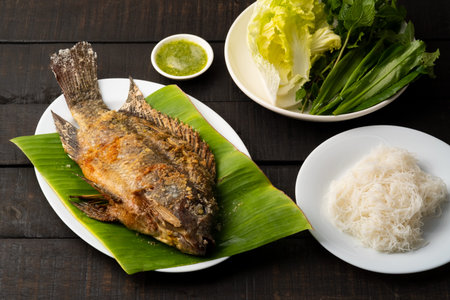 salt-crusted grilled Tilapia fish (Pla Pao Kluer)