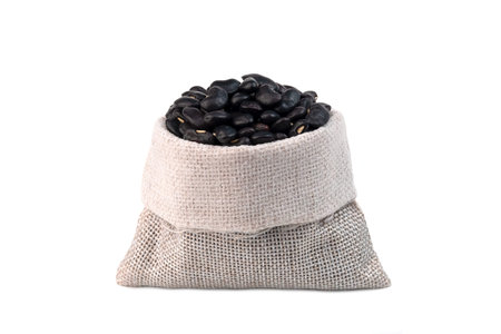 Black beans in the sack isolated on white background