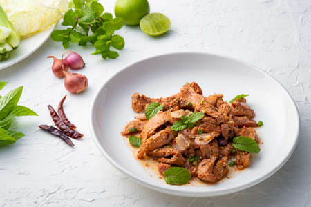 Popular Thai food.Spicy Grilled Pork Salad,grill pork with Charcoal and sliced mixed with lime juice,fish sauce,sugar and chilli flakes (Moo Nam Tok)の写真素材