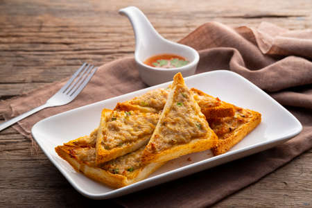 Fried Bread with Minced Pork Spread in white plate ,fry in the Air fryer,traditional snacks and appetizers in Thailandの写真素材