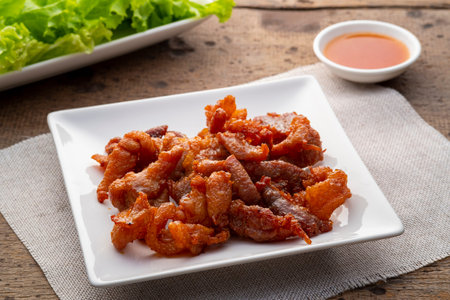 Deep fried pork (Mu Thod) in white plate with chilli sauce,Thai food