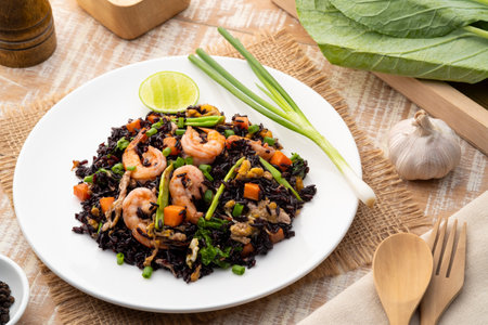 Healthy fried riceberry rice (brown jasmine rice) with shrimp and kale carrot in white plateの写真素材