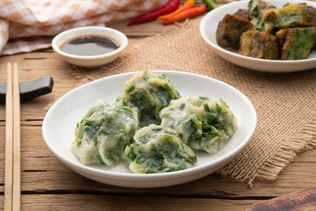 Chinese Chive Dumplings,Steamed Dumpling stuffed with Garlic Chives on white plate with sauceの写真素材