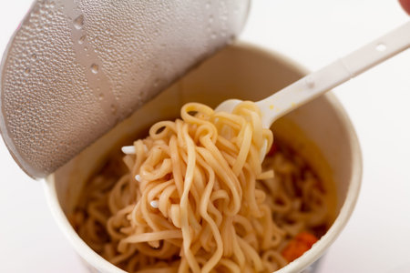 Close up Cup of Instant Noodles with a Plastic Fork