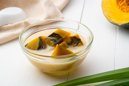 Coconut Milk Stewed Pumpkin,Thai dessert boiled sliced Pumpkin fruit in coconut milk with palm sugar in glass bowlの写真素材