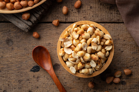 Close up Roasted peanuts in wooden bowl. rich in protein, fat, and fiberの写真素材