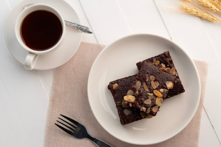 fudge almond brownies.Chocolate Brownie with Almond Sliced Topping in white plate.Top view.の写真素材
